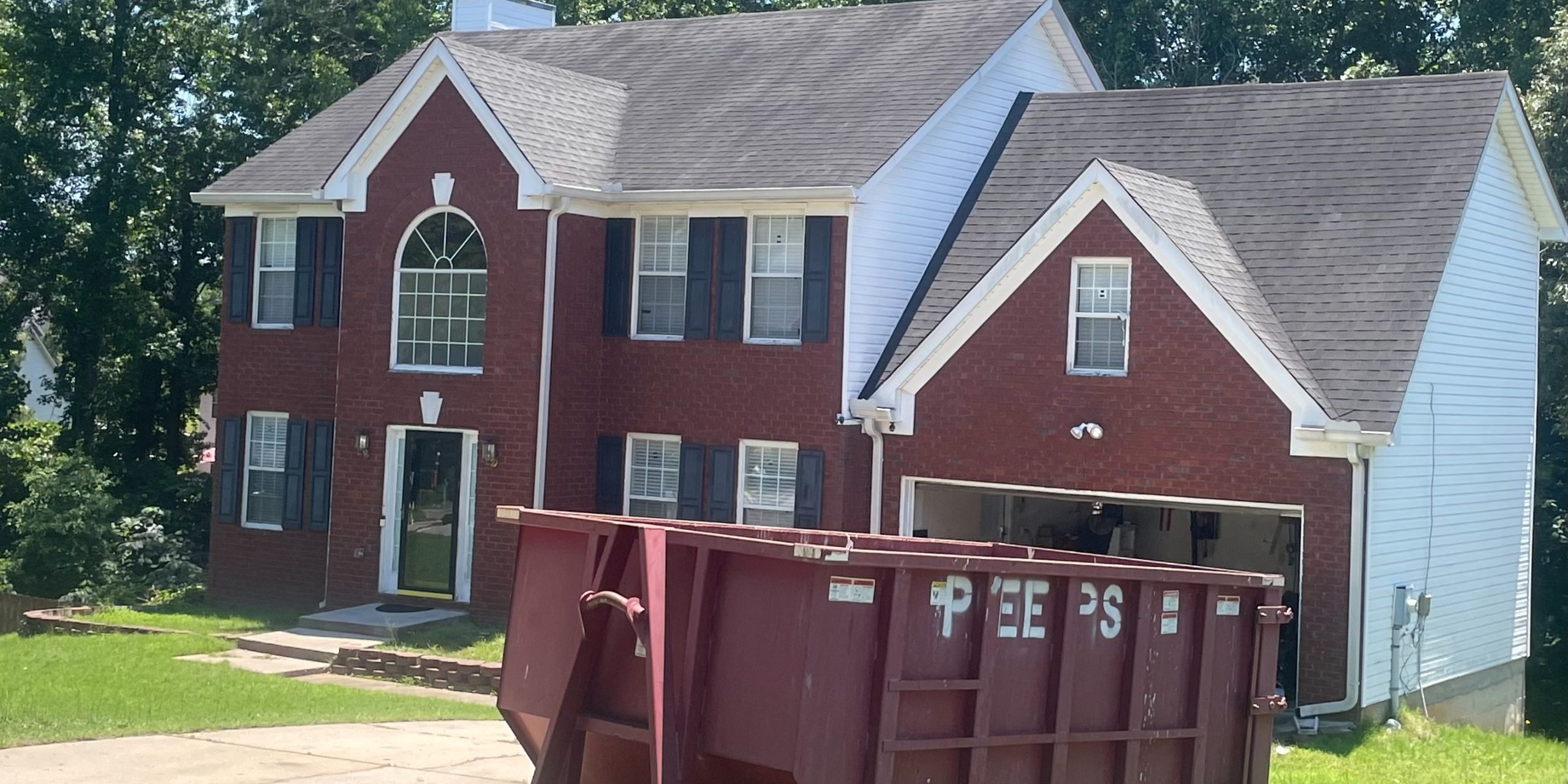 Riverdale 20 yard remodel Dumpster rental for a Riverdale GA job site with a Peeps Containers roll-off dumpster placed for contractor cleanup