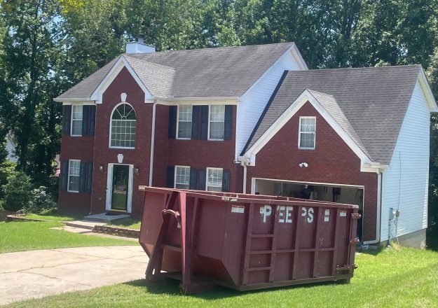 Riverdale 20 yard remodel Dumpster rental for a Riverdale GA job site with a Peeps Containers roll-off dumpster placed for contractor cleanup