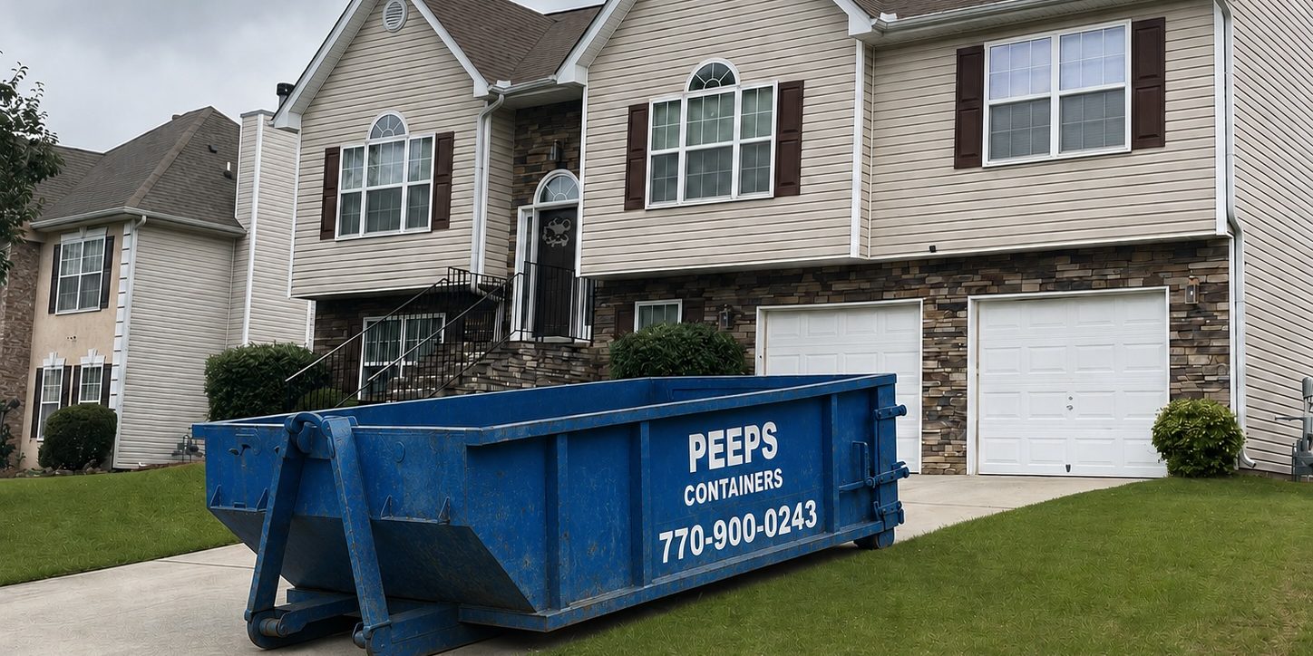 Residential Cleanout Dumpster Rental in Atlanta Blue dumpster labeled 'Peeps Containers' sits in the driveway of a beige two-story house with stone veneer and white garage doors.