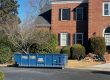 Blue 15-yard Peeps Containers dumpster placed in an Atlanta residential driveway