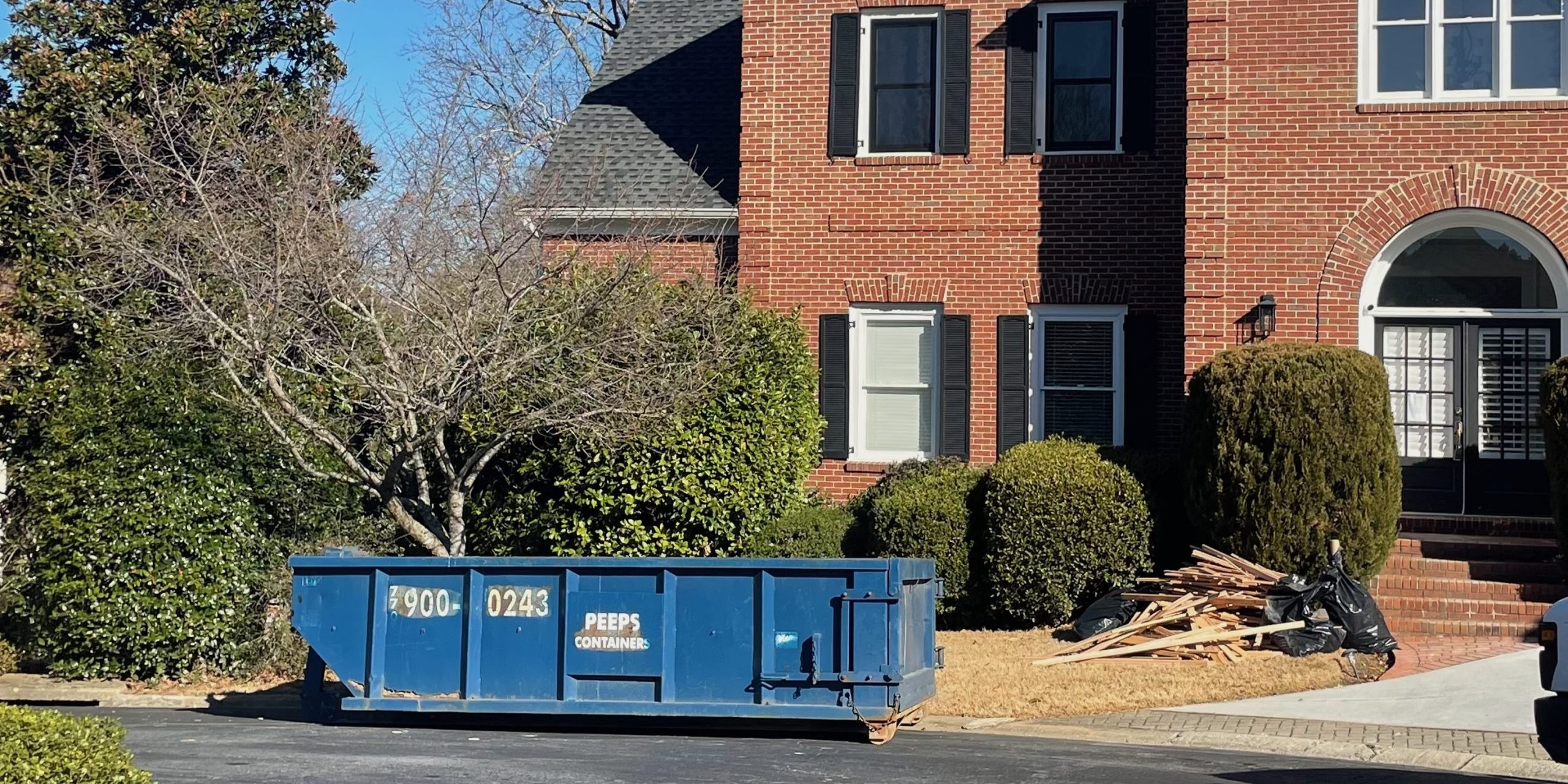 15 yard Smyrna flooring replacement Already had a picture from here Blue 15-yard Peeps Containers dumpster placed in an Atlanta residential driveway