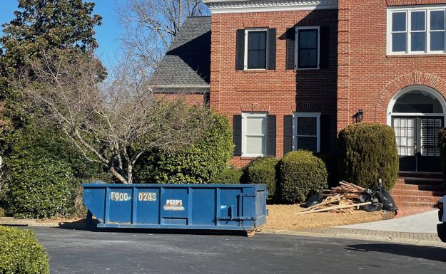 15 yard Smyrna flooring replacement Already had a picture from here Blue 15-yard Peeps Containers dumpster placed in an Atlanta residential driveway